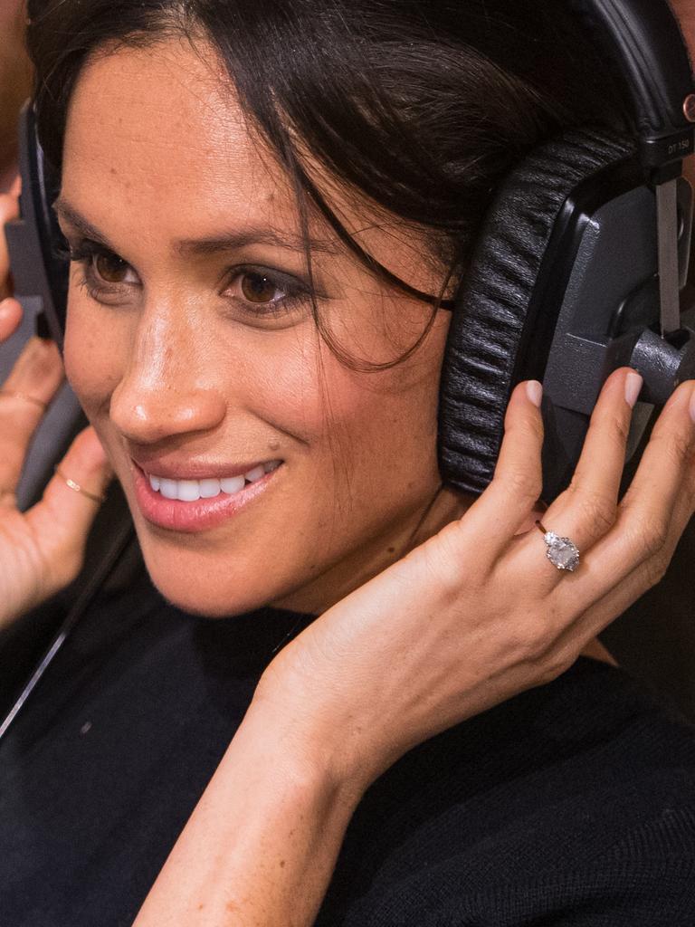 Prince Harry and Meghan Markle listen to a broadcast through headphones at Reprezent 107.3FM in Pop Brixton on January 9, 2018 in London, England. The Reprezent training programme was established in Peckham in 2008, in response to the alarming rise in knife crime, to help young people develop and socialise through radio. Picture: Getty Images