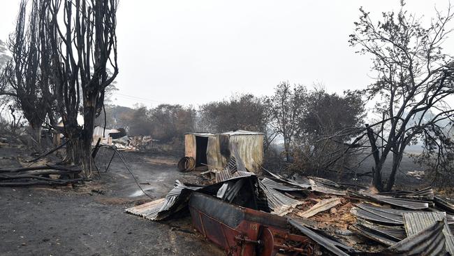A burnt-out house at Cobargo. NSW people who lost their homes won’t have to pay stamp duty if they decide to buy a new home instead of rebuilding, the NSW Government has announced. Picture: Saeed Khan/AFP