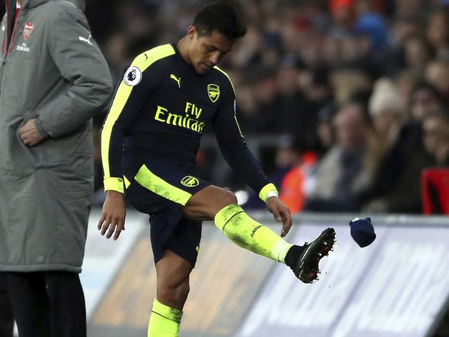 Arsenal's Alexis Sanchez shows his frustration at being substituted for Danny Welbeck during the English Premier League soccer match between Swansea City and Arsenal at the Liberty Stadium, Swansea, Wales, Saturday, Jan. 14, 2017.(Nick Potts/PA via AP)