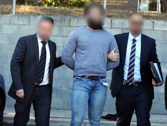 The Joint Counter-Terrorism Taskforce takes Tamim Khaja into custody. Picture: Supplied by NSW Police