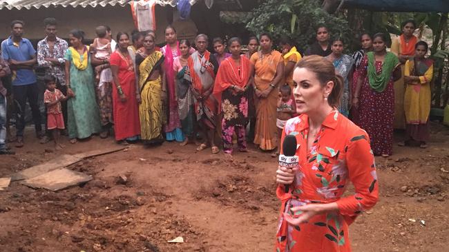 Peta Credlin speaks with locals living in a village, Navsacha Pada, in central Mumbai without electricity.