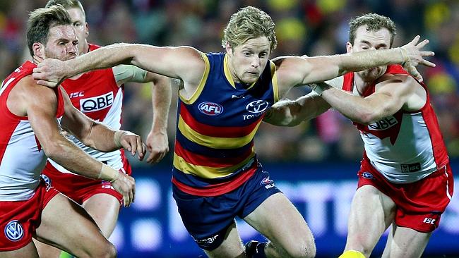 AFL — Adelaide Crows v Sydney Swans at Adelaide Oval. Rory Sloane holds off Ben McGlynn and Tom Mitchell. Picture Sarah Reed