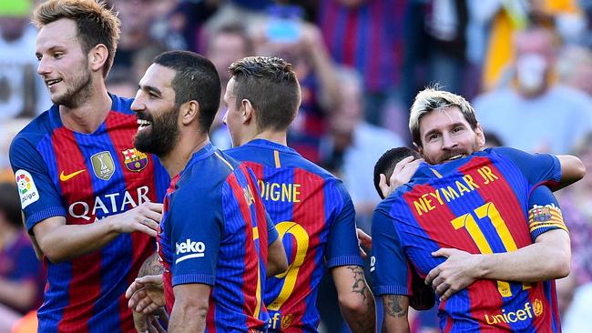 Lionel Messi (L) of FC Barcelona celebrates with his teammates after scoring.