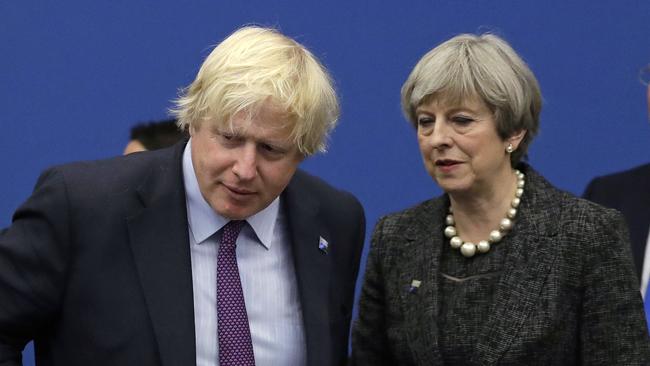 British Prime Minister Theresa May talks with fromer British foreign minister Boris Johnson.