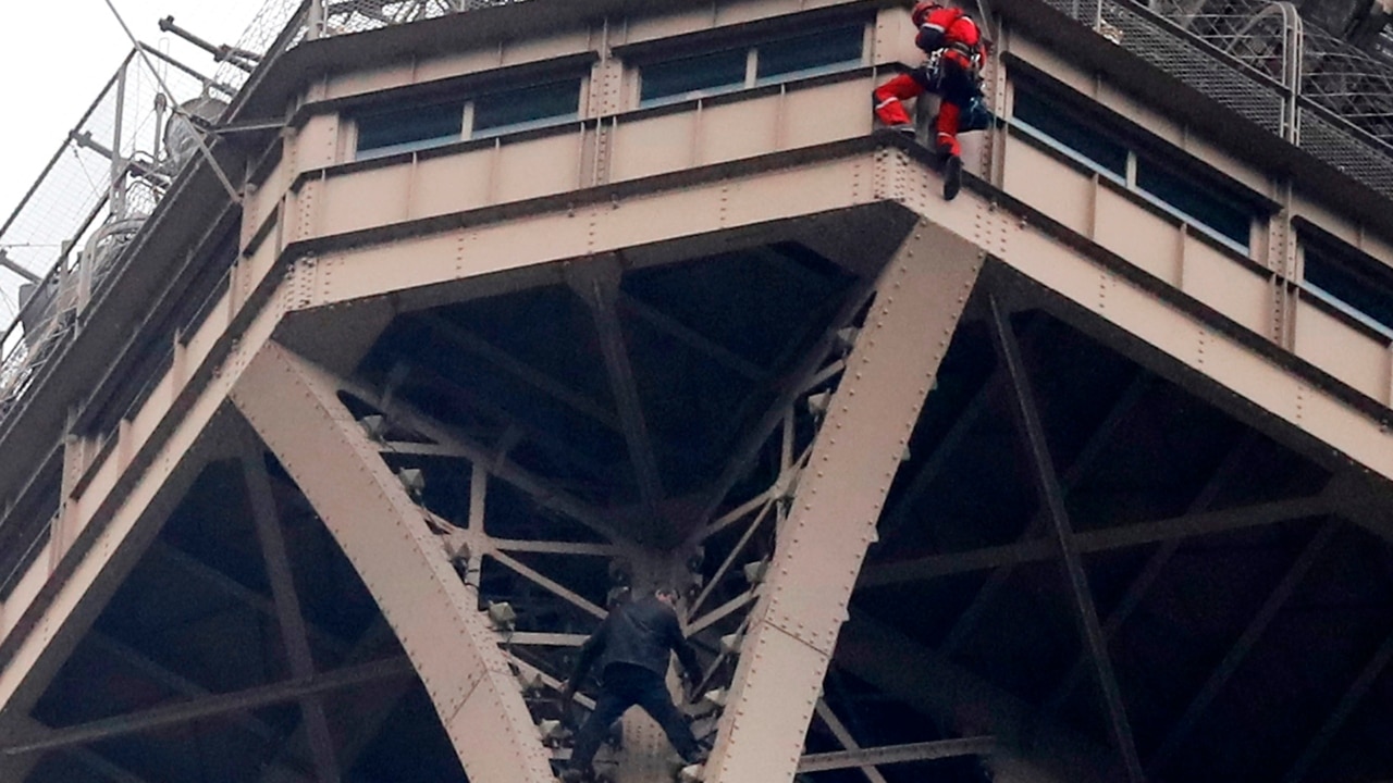 Man climbs Eiffel Tower, clings to side for seven hours