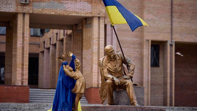 A monument for Ukrainian poet, writer, artist, public and political figure Taras Shevchenko decorated with the Ukrainian flag in town of Balakliya.