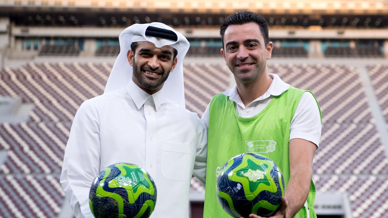 The general secretary of the World Cup's organisation committee Hassan Al-Thawadi and the World Cup ambassador Xavi Hernandez (R). Photo: Sven Hoppe/dpa
