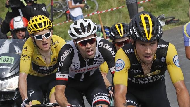 Stage winner Slovenia's Primoz Roglic is followed by Netherlands' Tom Dumoulin, left, and Britain's Geraint Thomas, wearing the overall leader's yellow jersey, as they climb Col d'Aubisque pass during the nineteenth stage of the Tour de France cycling race over 200.5 kilometers (124.6 miles) with start in Lourdes and finish in Laruns, France, Friday July 27, 2018. (AP Photo/Christophe Ena )