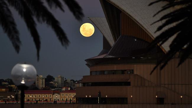 The moon rises over the Opera House in Sydney on May 26, 2021, ahead of a total lunar eclipse. Picture: AFP