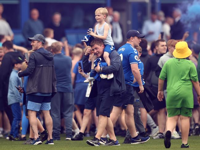 Fans of Everton invade the pitch and celebrate after their side’s victory staved off relegation. Picture: Naomi Baker/Getty Images