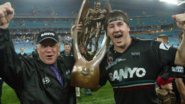 Penrith Coach John Lang and son Martin celebrate the Panthers 2003 grand final win over the Roosters.