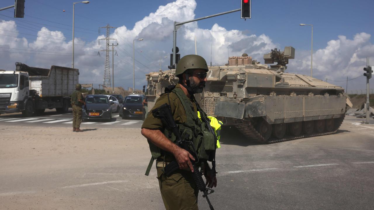 Traffic is stopped as Israeli armoured vehicles advance towards the border on October 15. Picture: Menahem Kahana / AFP