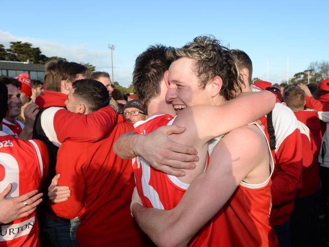 We did it: Red Hill players Tom McEnroe and Jonathon Ross embrace after the final siren. Picture: Chris Eastman