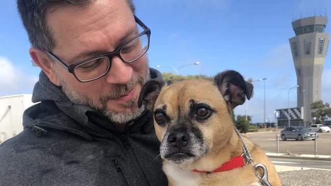 Damien Thaller is reunited with his family’s dog Rosie after she was released from quarantine, while his wife and daughter are stranded in Canada.