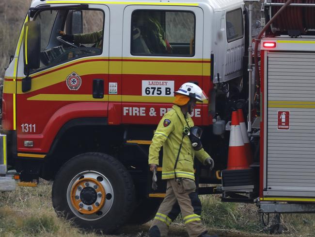 Fire and Emergency crew prepare to battle bushfire near a house in the rural town of Canungra in the Scenic Rim region of South East Queensland, Friday, September 6, 2019. Residents of the Gold Coast hinterland community of Sarabah, where a fast-moving bushfire is spreading, has been told to leave and move to the Canungra Showgrounds. (AAP Image/Regi Varghese) NO ARCHIVING