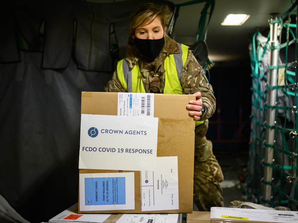 Royal Air Force personnel load a batch of the COVID-19 vaccine onto a Voyager aircraft bound for the Falkland Islands at RAF Brize Norton in England on February 1. Picture: Leon Neal/Getty Images