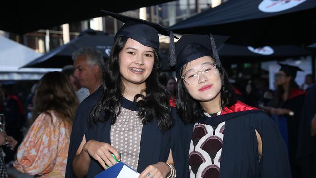 Jennifer Foster and Grace Hu celebrate graduation. Picture: Alan Barber