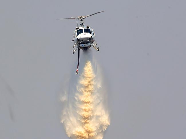 Firefighters work to extingush a bushfire near Yiinnar in Gippsland, Victoria, Monday, March 4, 2019. The fires in Gippsland started after lightning strikes on Friday afternoon, with hundreds of emergency workers deployed to fight the blazes. (AAP Image/David Crosling) NO ARCHIVING