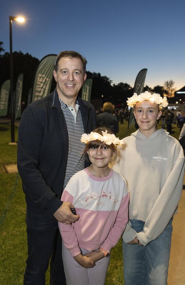 David Knott with daughters Jane (centre) and Hannah Knott at the Symphony Under the Stars concert performed by the Queensland Symphony Orchestra in Queens Park Amphitheatre for Carnival of Flowers, Friday, October 4, 2024. Picture: Kevin Farmer