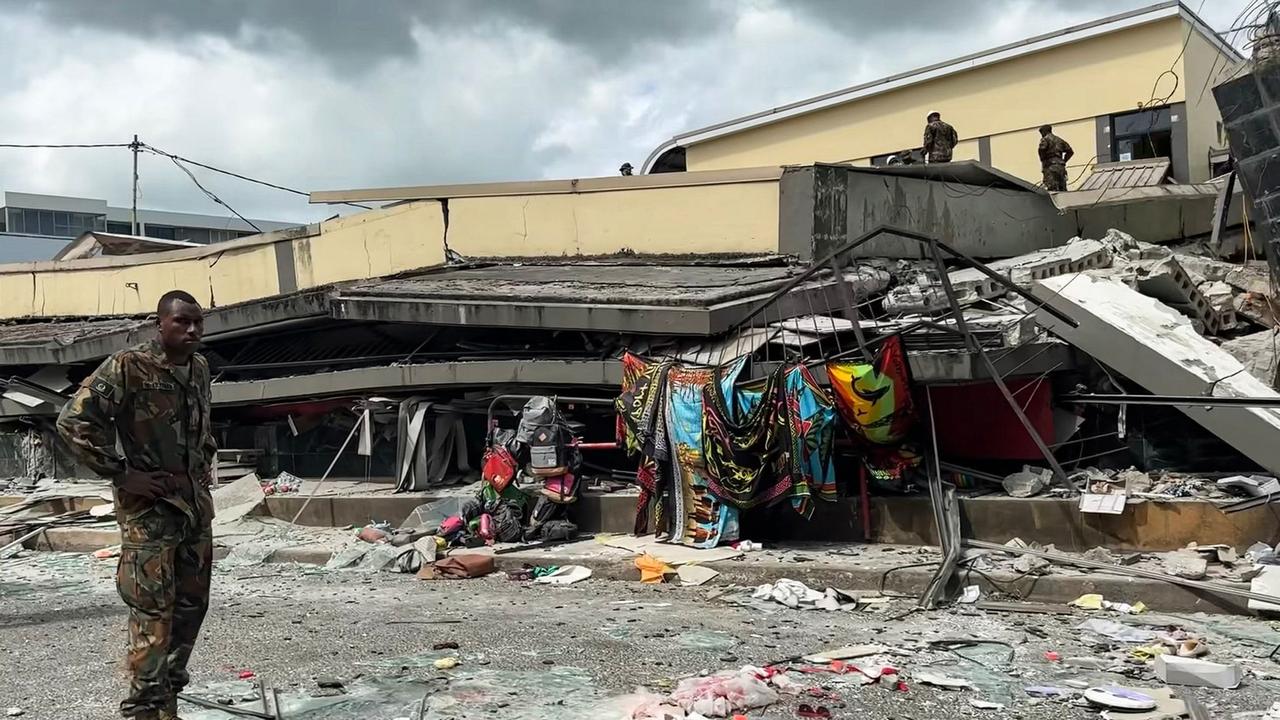 A member of security can be seen inspecting a collapsed building in Vanuatu's capital Port Vila after a powerful earthquake hit the Pacific Island. (Photo by MICHAEL THOMPSON / Facebook account of Michael Thompson / AFP