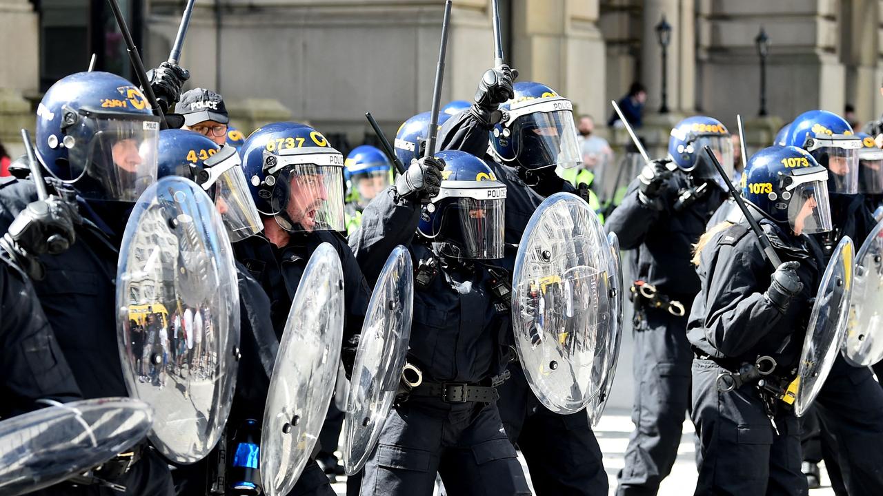 Police officers in riot gear try to control the rioters. Picture: Peter Powell / AFP