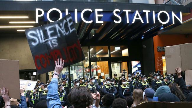 Police line up amid the protest in Melbourne. Picture: Wayne Ludbey