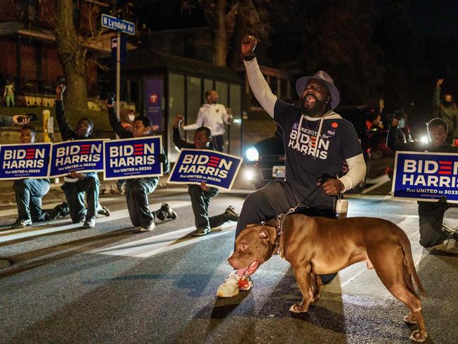 Former NFL star Tyrone Carter leads a group of kids near a polling place in Minneapolis, Minnesota Picture: AFP