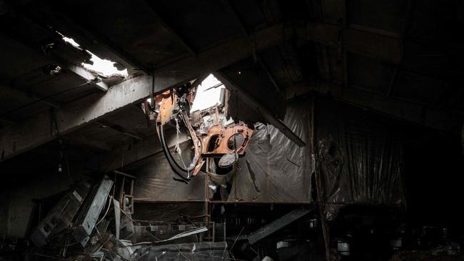 Parts of a tank hanging from the damaged roof of a building in Kozacha Lopan. Only three miles from the Russian border, it was liberated by Ukrainian forces two weeks ago but destruction remains in the rural town.