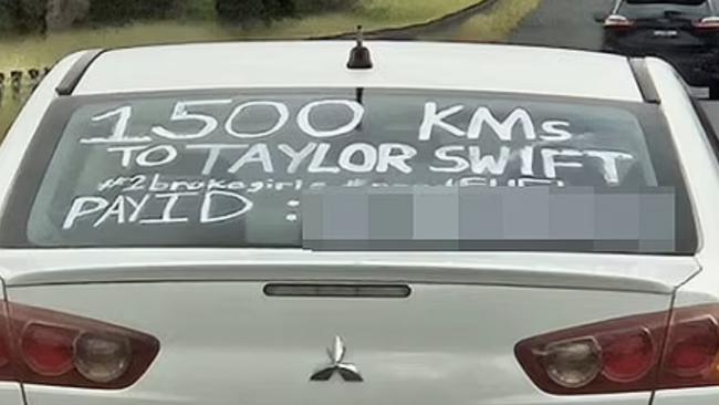 A sign they scribbled on the back window of their car has attracted some negative attention.