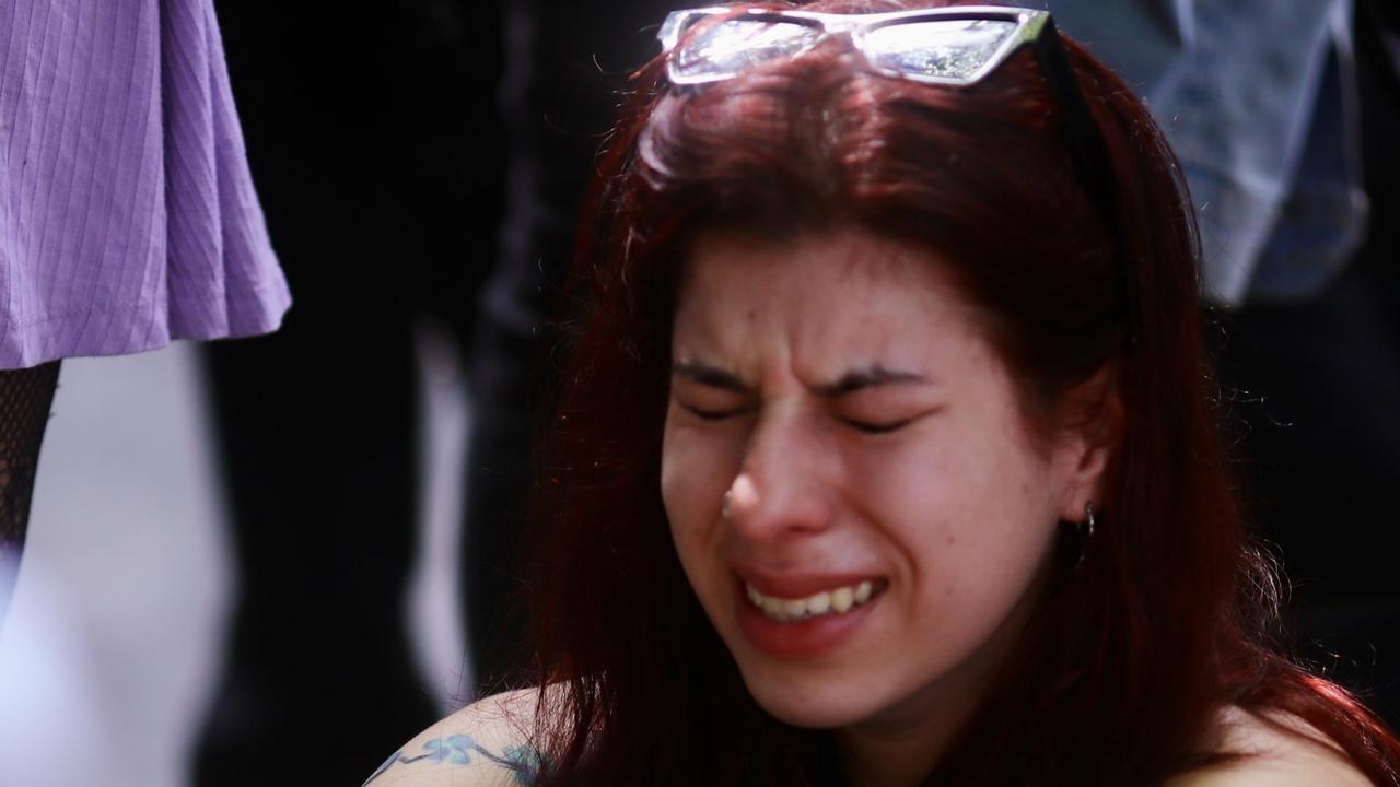 A fan cries at the memorial outside the CasaSur Hotel. Picture: Marcos Brindicci/Getty Images