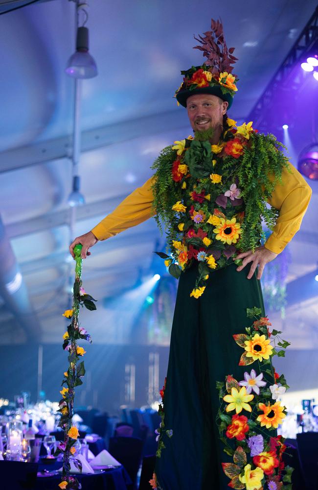 A floral-cladded man on stilts welcomed guests into the Beach Pavilion at Mindil Beach Casino.Picture: Pema Tamang Pakhrin