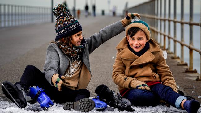 Gracie Centenera, 8, and George Archontidis, 7, get into the festival spirit with ice and skates on the Glenelg Jetty. Picture: Mike Burton