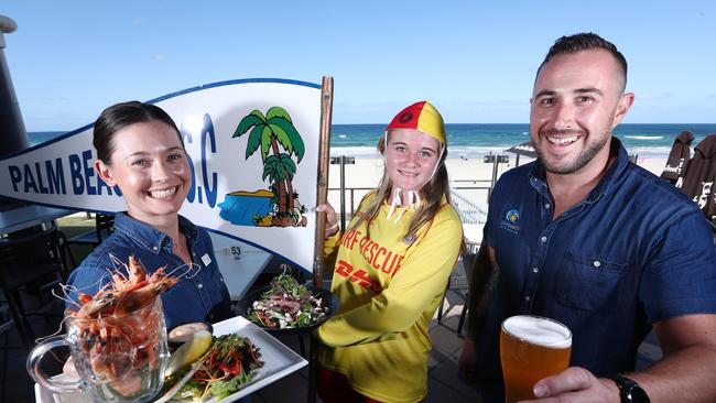 Palm Beach SLSC employees Emily Signorini, Samantha Jennings and Andrew Mihalka celebrate being voted the Coast's best surf club. Picture: Jason O'Brien.