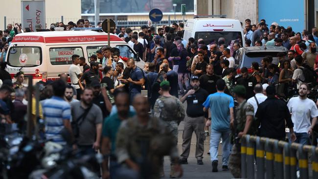 Ambulances and bystanders bring the wounded to the American University of Beirut Medical Centre. Picture: AFP