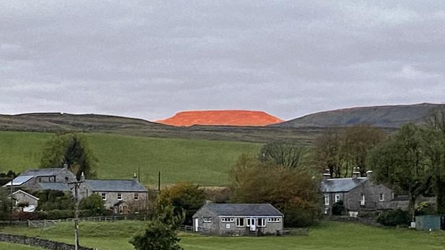 The sun hit Ingleborough Mountain in the UK at just the right angle one morning turning the peak a bright red, not dissimilar to the Territory's famous Uluru. Picture: Andy Meadley/ Magnus News