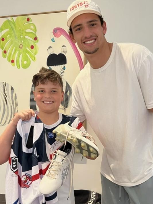 Roosters centre Billy Smith with young NRL fan Beau Haigh.