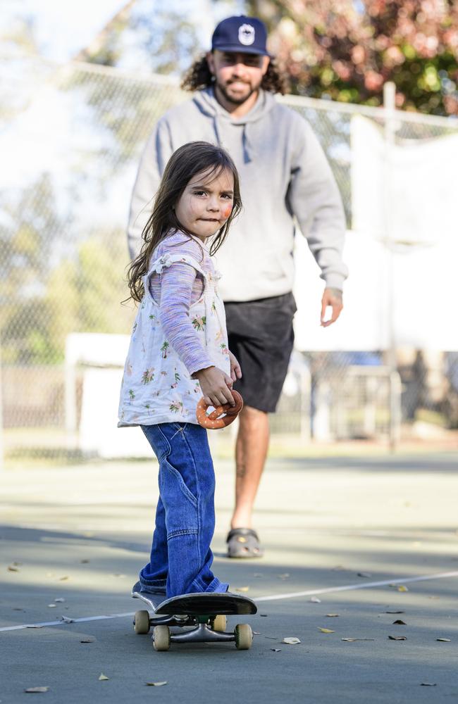 Mayii Weribone learns to skateboard with the help of dad Josh Weribone at Sadie's Day Out, a special community event to celebrate the life of five-year-old crash victim Sadie, held at Cambooya State School, Saturday, June 7, 2025. Picture: Kevin Farmer