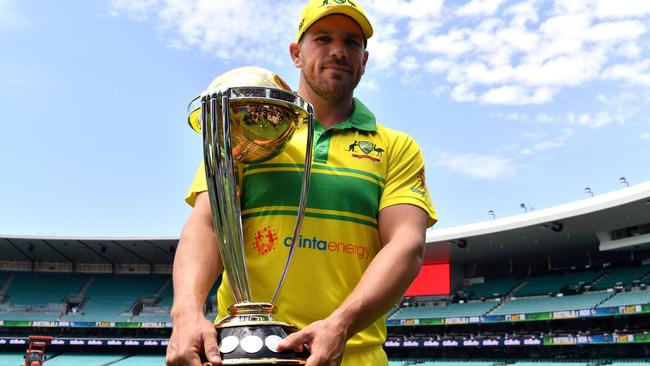 Australian captain Aaron Finch and the prize Australia are defending. Picture: AFP