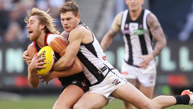 Taylor Adams wraps up Essendon captain Dyson Heppell on Anzac Day. Picture: Michael Dodge/Getty Images.