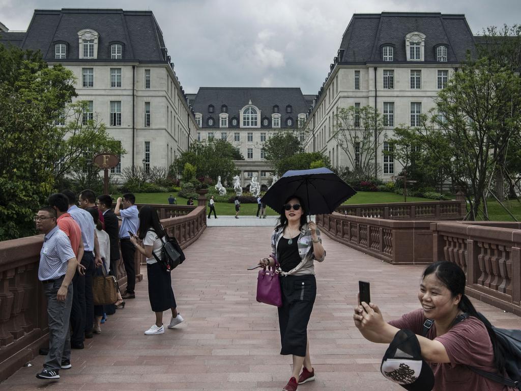 A woman takes a picture in front of a Huawei’s 'Versailles'. Picture: Getty