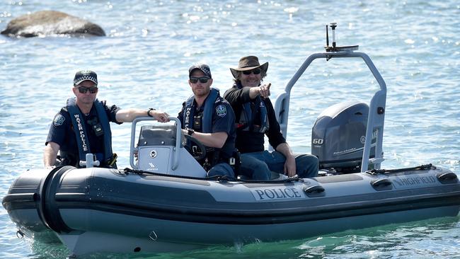 Derek Robinson is brought ashore by a police boat at Encounter Bay. Picture: NCA NewsWire / Naomi Jellicoe