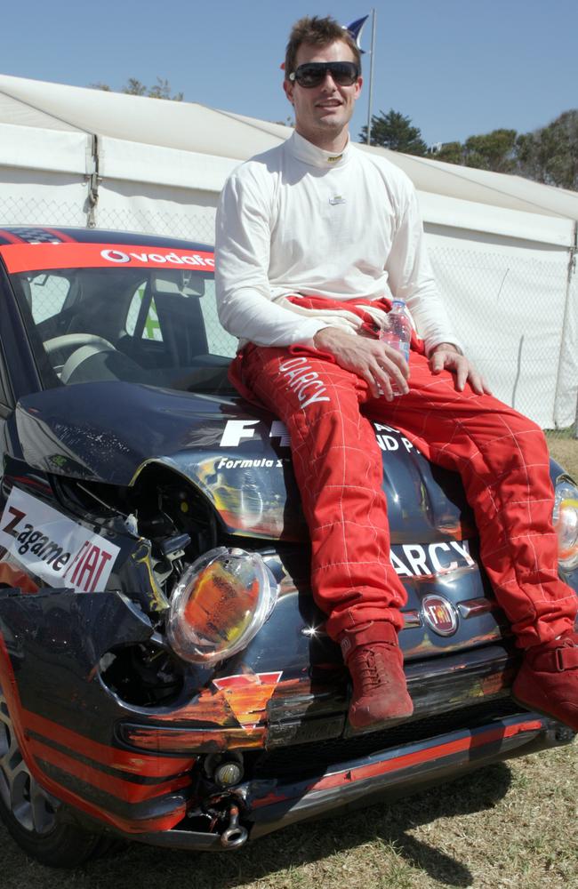 Luke Darcy with his smashed up Mini in the celebrity race.