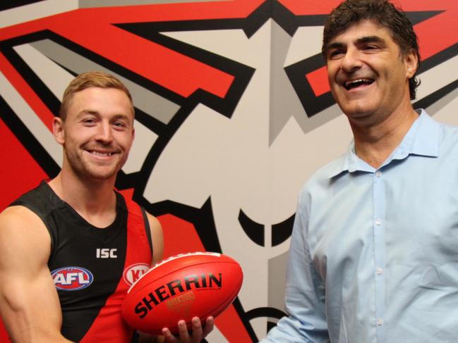 12 October, 2017: Former GWS Giants midfielder Devon Smith after he joined Essendon today via a trade.He shakes hands with Essendon list manager Adrian Dodoro.Pictures: SUPPLIED