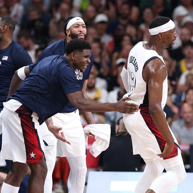 Anthony Edwards pats Bam Adebayo on the back. (Photo by Gregory Shamus/Getty Images)