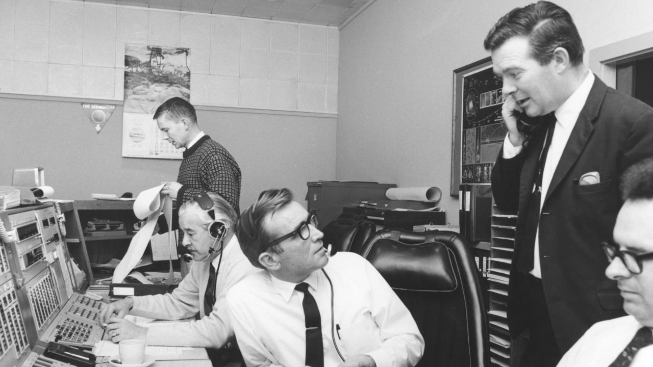 The team at Honeysuckle Creek’s main operations room during preparations for Apollo 11's landing. From left, John Saxon (standing), Ken Lee, Station Director Tom Reid, Mike Dinn, and Ian Grant. Picture: AAP/Supplied by Honeysuckle Creek, Mike Dinn