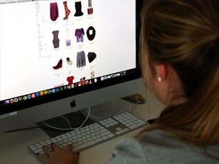 A woman looks at an online clothes store