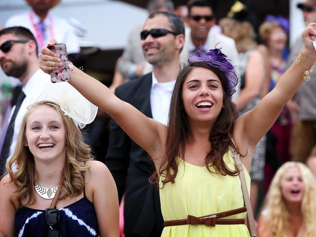 Melbourne Cup Day 2014 at Flemington Racecourse. Punters cheer on the horses during the last race. Picture: Mark Stewart