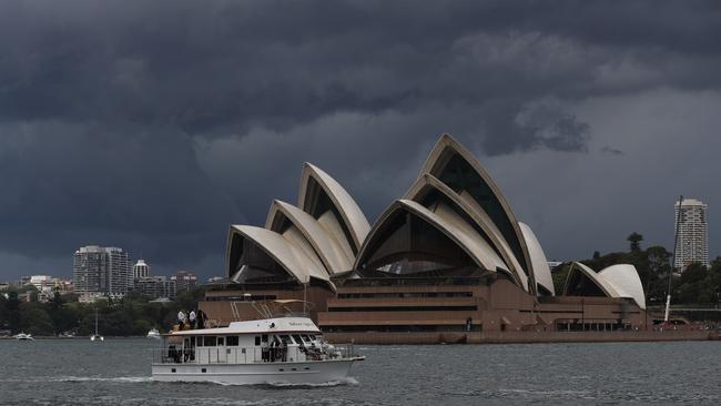 Ominous skies above Sydney Harbour on Friday. Picture: John Grainger