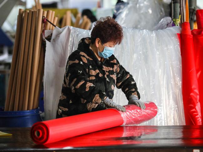 A worker packages cloth at a textile factory in Hangzhou, in China. Picture: AFP