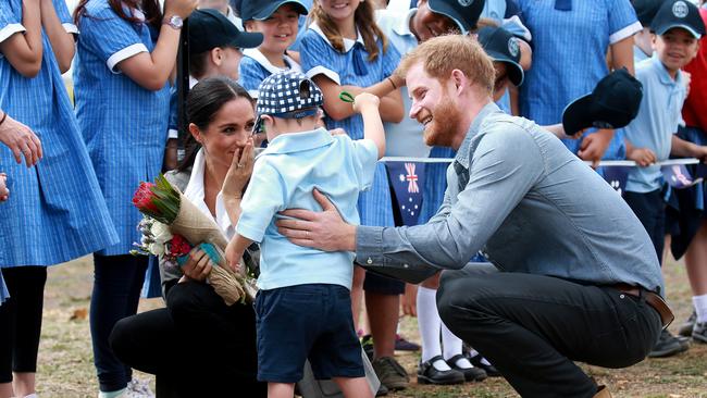 The Duke and Duchess of Sussex, Prince Harry and Meghan Markle, are moved by Buninyong Public School student Luke Vincent after he gave them hug. Picture: Toby Zerna